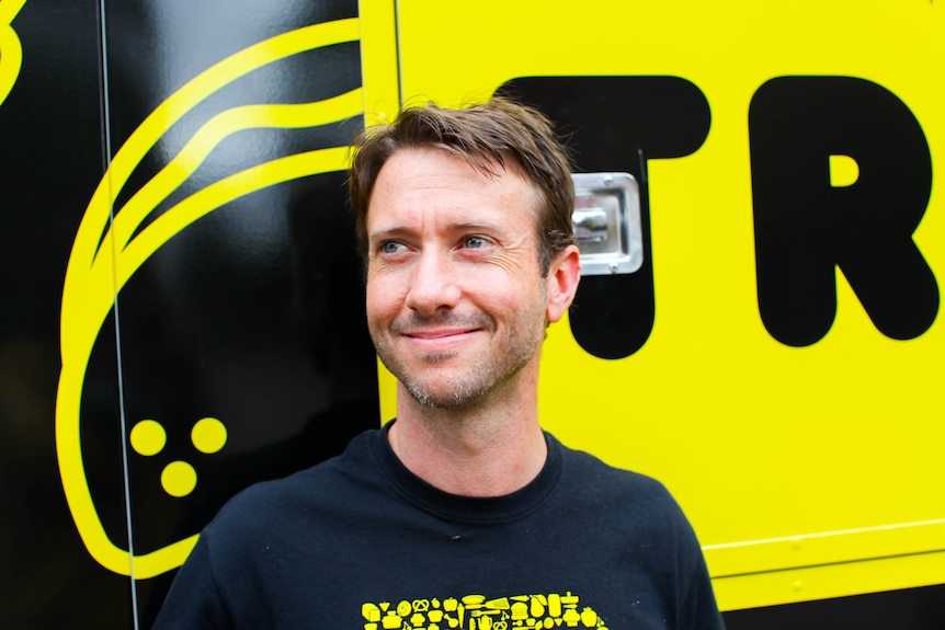 Travis Harvey, the executive chef at food rescue charity OzHarvest, stands in front of their new truck