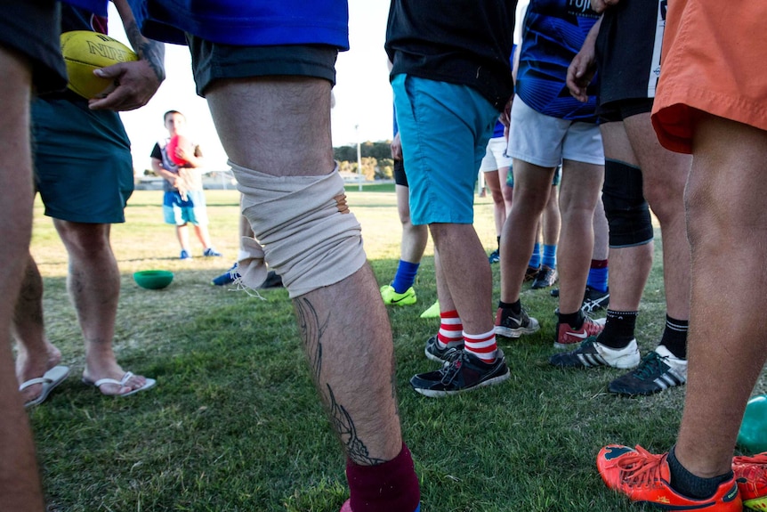 Players gather during Football Club team training, north Tasmania.