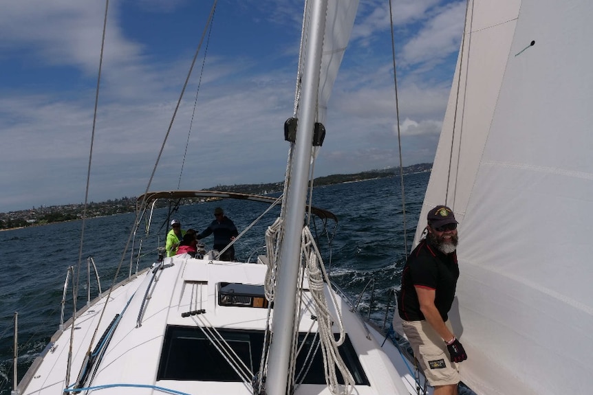 Adrian Whitby on the fore deck of Isa Lei yacht on Sydney Harbour.