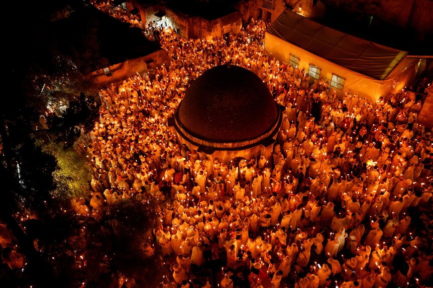 Ethiopian Orthodox worshippers hold candles during the Holy Fire ceremony at the Church of the Holy Sepulchre.