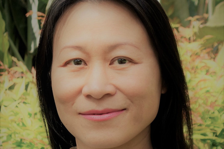 Close up of a woman smiling for camera.