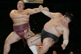 Sumo wrestler Kisenosato Yutaka pushes another wrestler