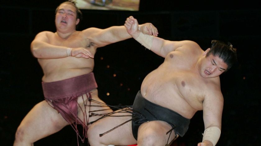 Sumo wrestler Kisenosato Yutaka pushes another wrestler