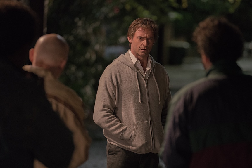Colour still of Hugh Jackman being confronted by three men in 2018 film The Front Runner.