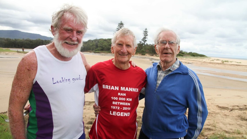 Three older, fit-looking men at a beach
