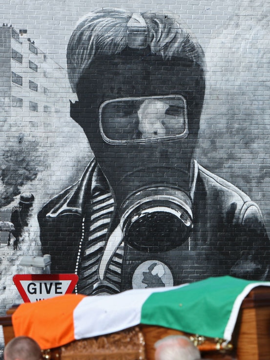 Pallbearers carry a coffin draped with a republican flag in Northern Ireland