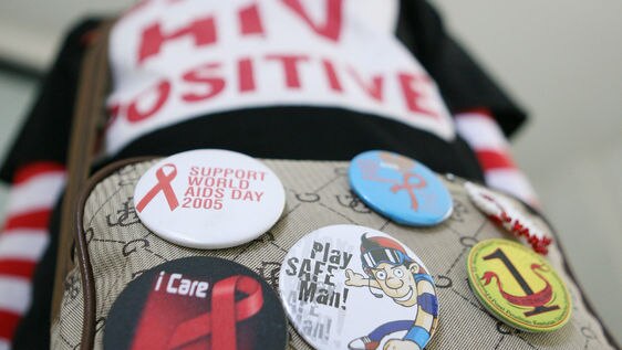 A HIV-infected woman wearing a 'HIV positive' shirt