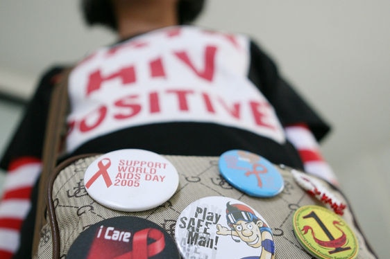 A HIV-infected woman with World AIDS day badges (AFP: Ahmad Zamroni)
