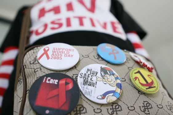 A HIV-infected woman wearing a 'HIV positive' shirt