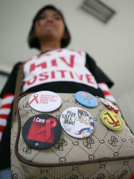 A HIV-infected woman wearing a 'HIV positive' shirt