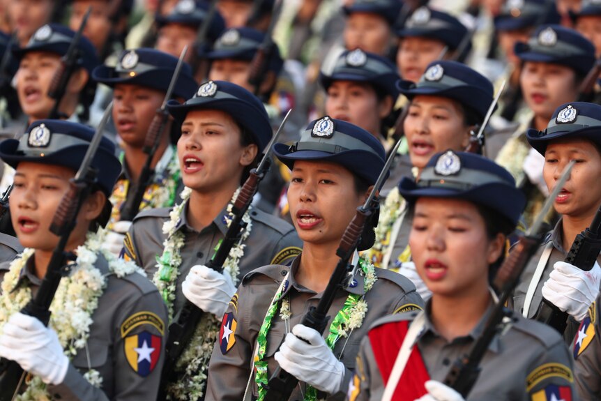 Women in police uniform holding rifles