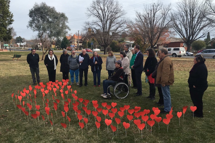 Sex abuse victims, family and community members gather at Centennial Park in Bathurst for a vigil.