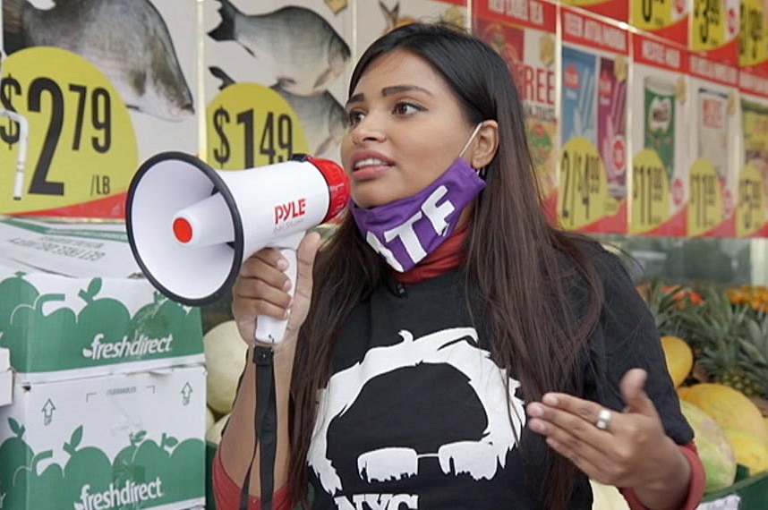 A woman speaks into a megaphone.