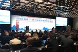 A delegation of Chinese and Australian business people seated at an investment event held in Sydney in May 2018.