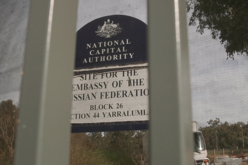 A National Capital Authority blue sign on a building site marking the planned future location for a Russian Embassy.