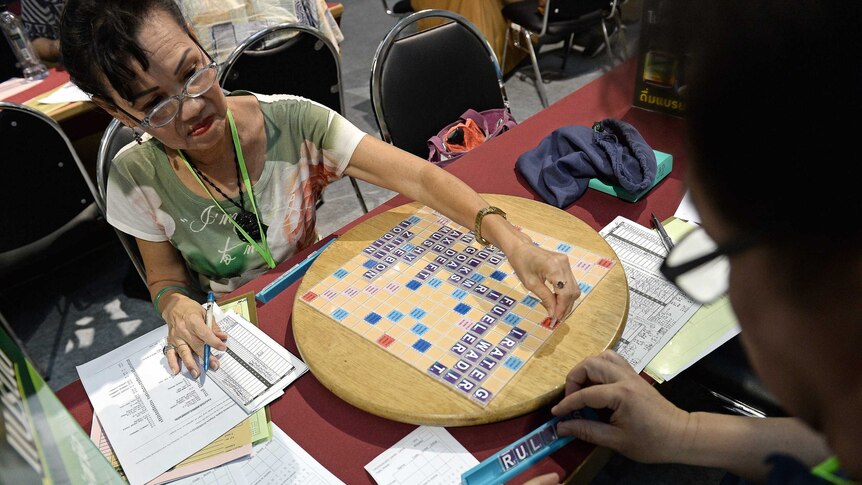 This picture shows participants playing a game of Scrabble during the King's Cup tournament, the world's biggest competition