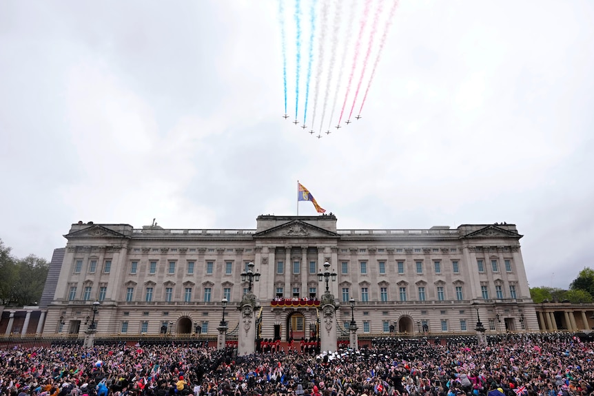 Nine planes leaving trails of red white and blue fly over the palace