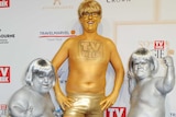 People dressed as logies in gold and silver body paint.