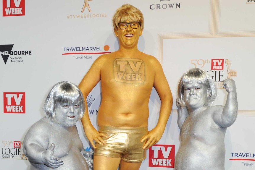 People dressed as logies in gold and silver body paint.