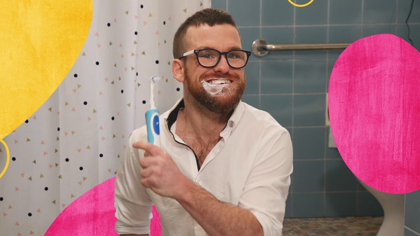 Writer and comedian Angus Thompson holding a toothbrush on the set of Terrible Pauly.