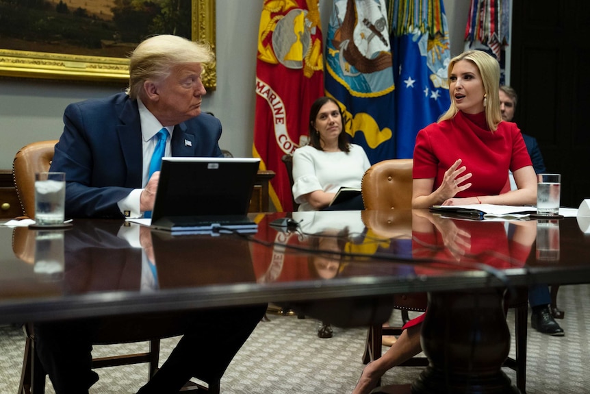 President Donald Trump listens as Ivanka Trump speaks during a meeting.