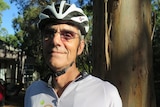Robin Warren wearing a helmet and cycling shirt.