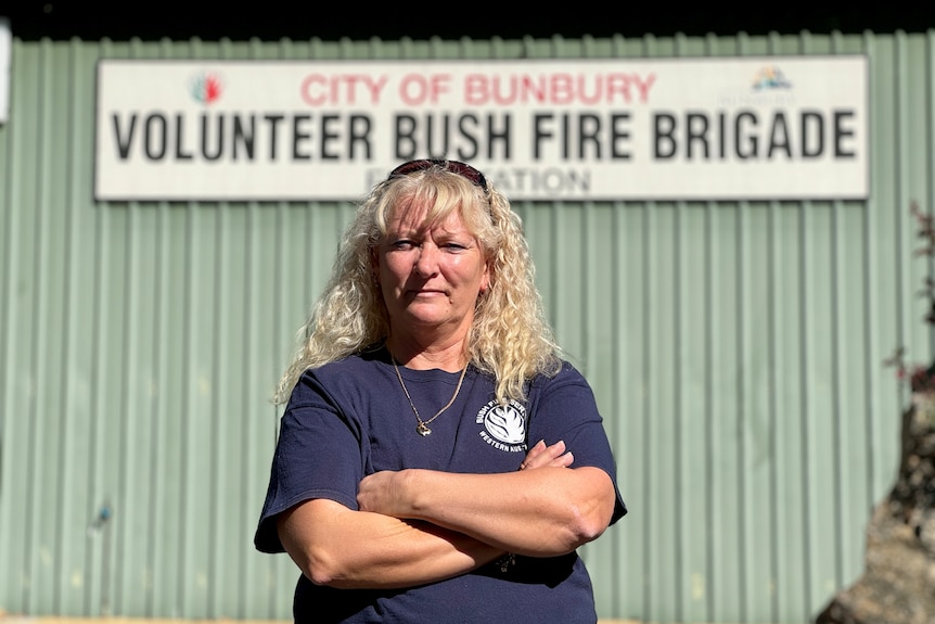 A women stand with crossed arms in from of Bunbury Volunteer Bush Fire Brigade station