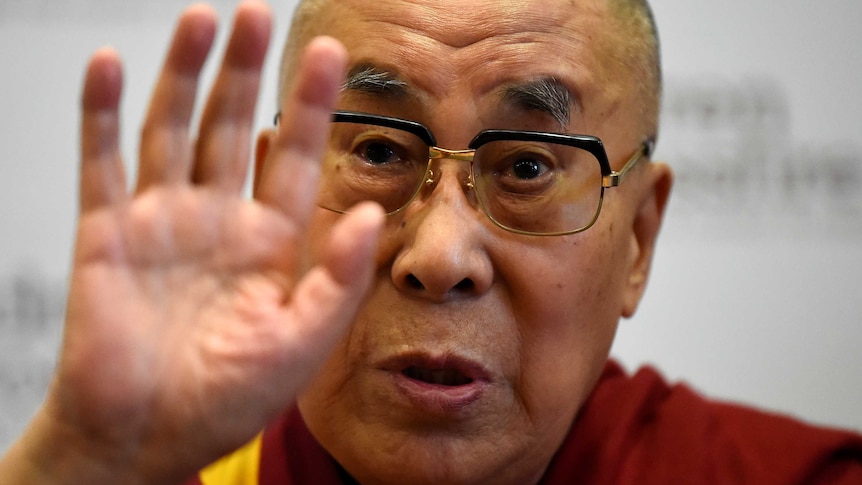 The Dalai Lama waves