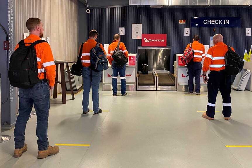 Miners check-in for their flight at Moranbah airport.