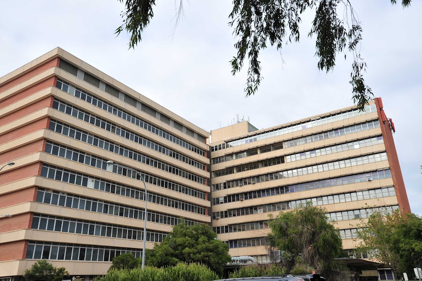 A large hospital building with two multi-storey wings visible