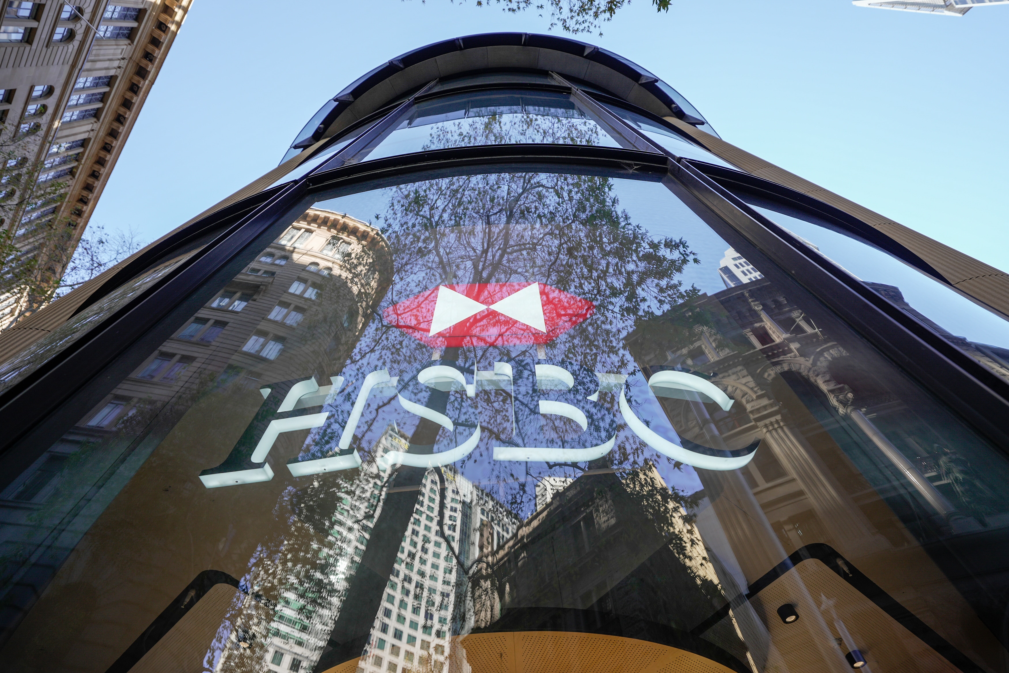 Low shot of the HSBC building in Sydney with the logo on large glass panels.