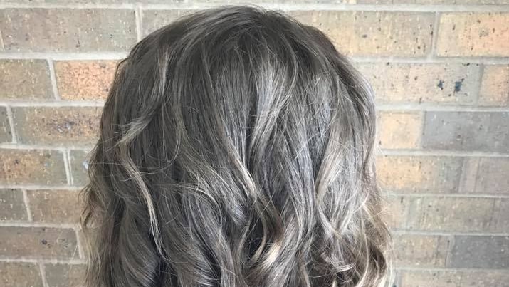 Back of teen's hair after it has been cut and curled