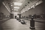 A black and white photograph of a grand art gallery.