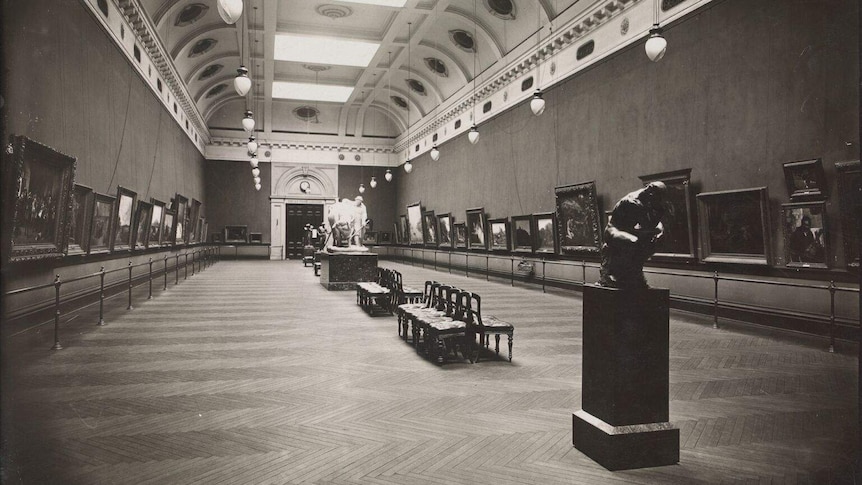 A black and white photograph of a grand art gallery.