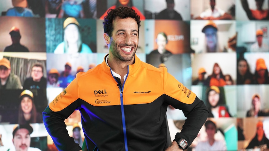 Daniel Ricciardo smiles looking off to one side