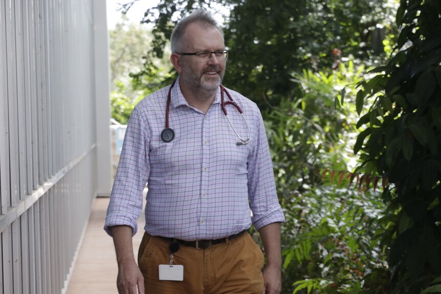 Dr Paul Lawton walking outside the Menzies research facility in Darwin.