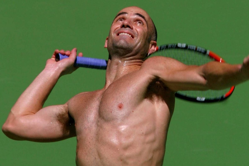 Andre Agassi shirtless and serving