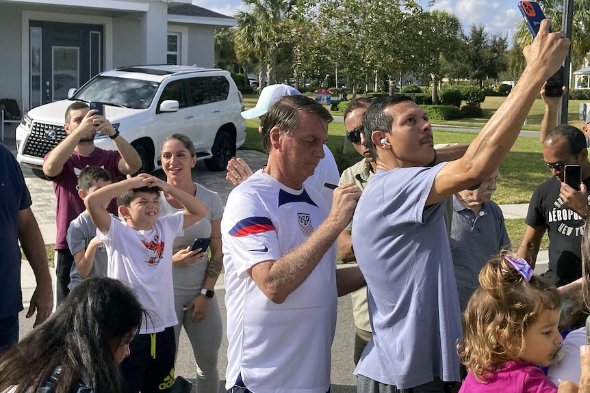 Former Brazil President Jair Bolsonaro meets with supporters outside a vacation home in Florida.