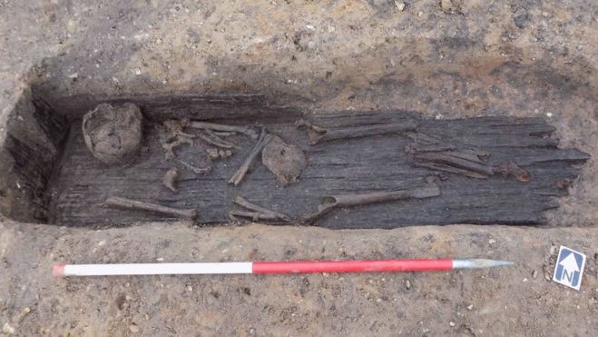 Human remains are seen in what is left of a wooden Anglo-Saxon coffin in England.