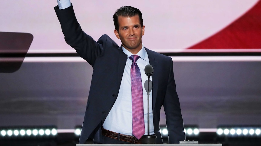 Donald Trump Jr gestures to the Republican crowd.