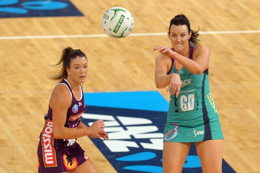 Bianca Chatfield of the Vixens passes as Verity Simmons of the Firebirds looks on.