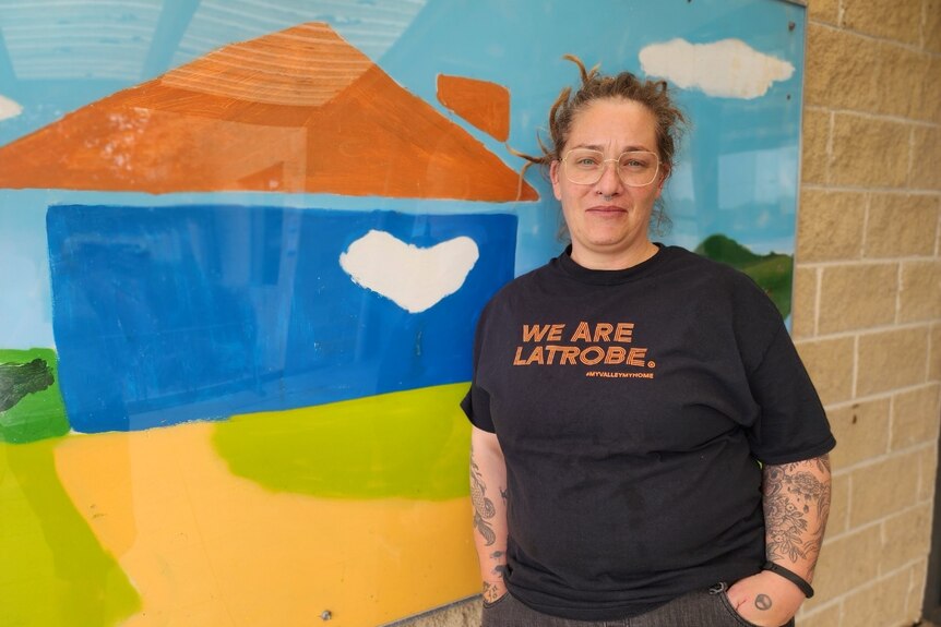 Brooke Mawson stands in front of a mural at the Community House in Gippsland