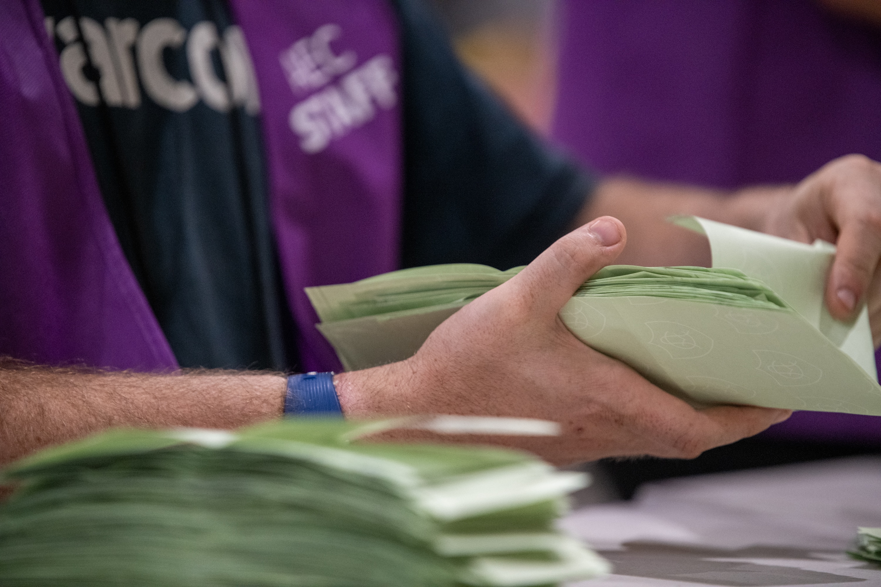 People counting votes in large room