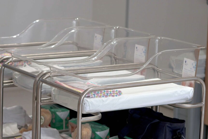 empty baby cribs at a maternity ward inside a hospital
