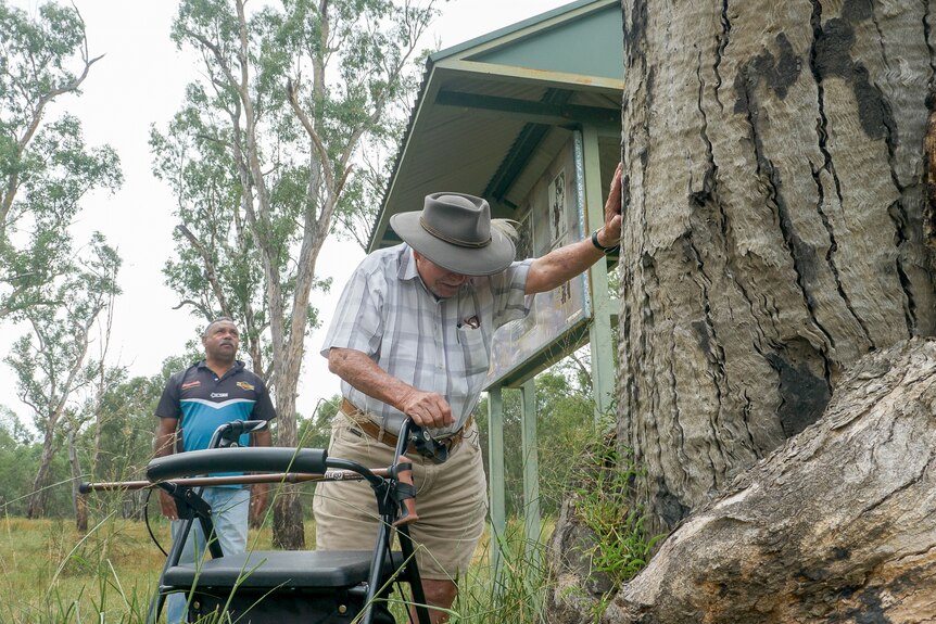 Kevin Waters holds a hand on a gum tree at Toomelah, New South Wales, March 2024.