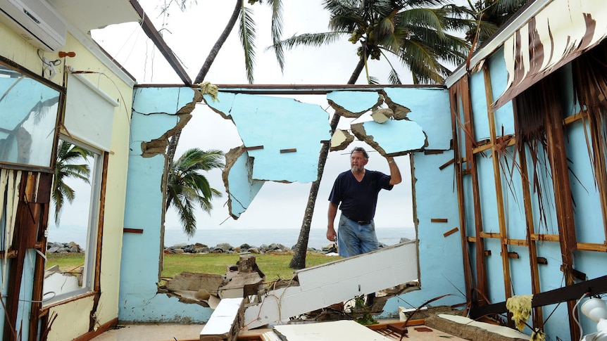 Greville Blank surveys his destroyed home in the devastated town of Tully Heads in Far North Queensland.