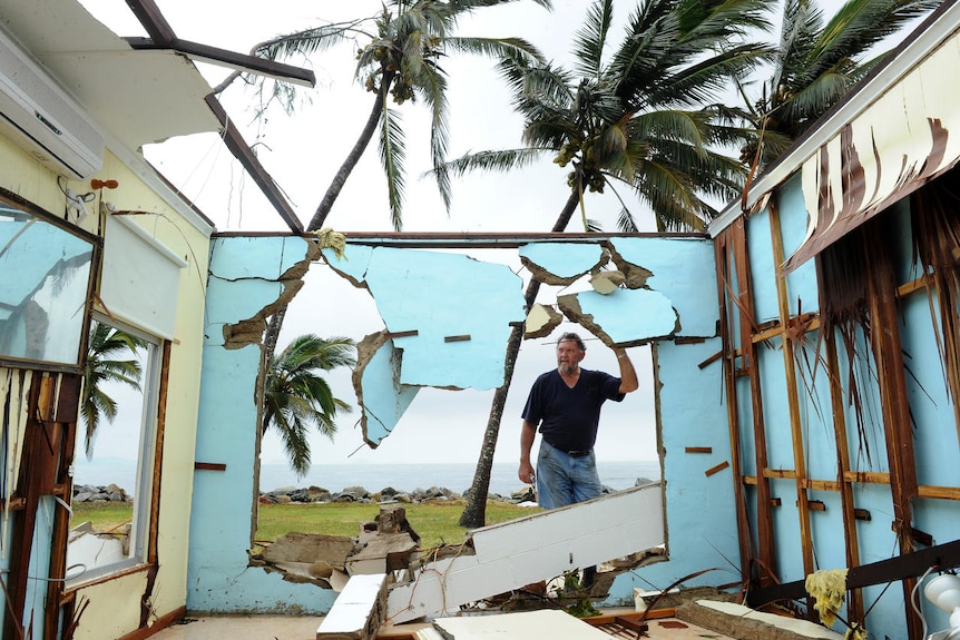 Greville Blank surveys his destroyed home in the devastated town of Tully Heads in Far North Queensland.