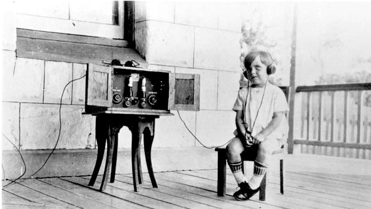 A child listening to a radio broadcast on a Mulgaphone 
