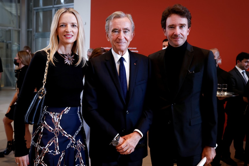 Bernard Arnault stands between his two oldest children