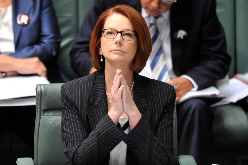 Prime Minister Julia Gillard listens during question time (AAP: Alan Porritt)